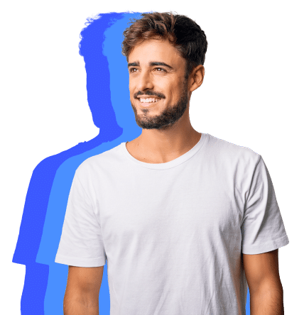 A Smiling Man With Hands In Pockets, Radiating A Relaxed Demeanor