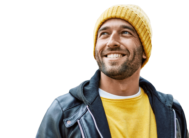 A Man Wearing A Yellow Beanie Black Jacket Smiles Warmly At The Camera