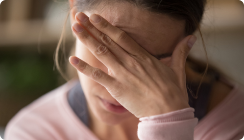 A Woman With Her Hands Covering Her Face, Expressing Surprise Or Distress