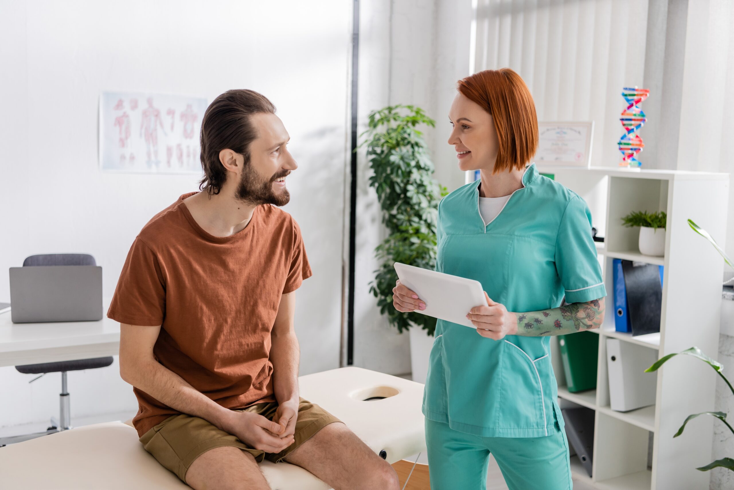 A Man &Amp; Woman Discuss Health And Rehabilitation Costs In A Doctor'S Office
