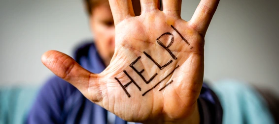 A Palm With The Word &Quot;Help&Quot; Written On It.