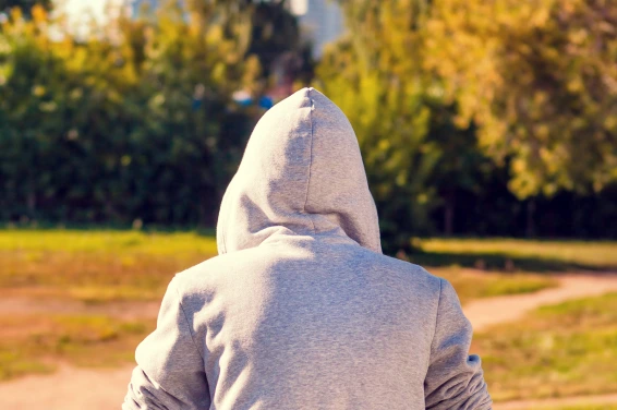The Back Of A Man Wearing A Hood.